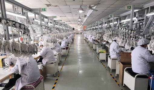 Workers produce reusable masks at Shanghai Juchen Infant and Children Garment Company. Photo: Shanghai Economic and Information Technology Committee