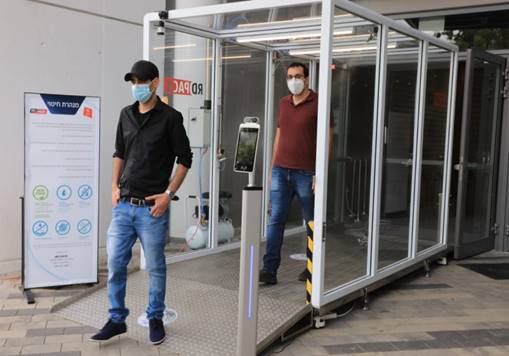 Bar-Ilan University researchers Dr. Eran Avraham (front) and Dr. Izaak Cohen (back) walk through a disinfection tunnel at Bloomfield Stadium (Credit: Yoni Reif)