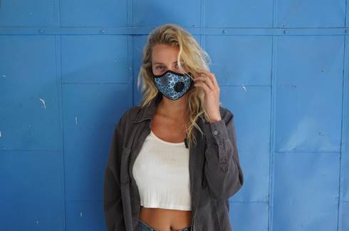A woman in a printed blue Vogmask.